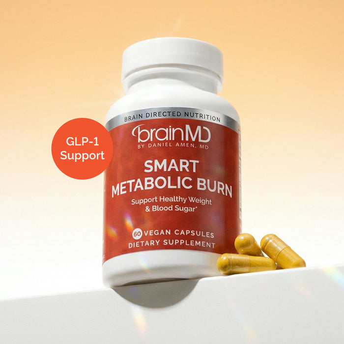Red supplement bottle with yellow capsules at the base against a light yellow background.