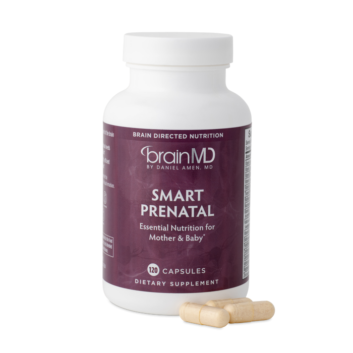 BrainMD Smart Prenatal: purple supplement bottle with capsules against a transparent background