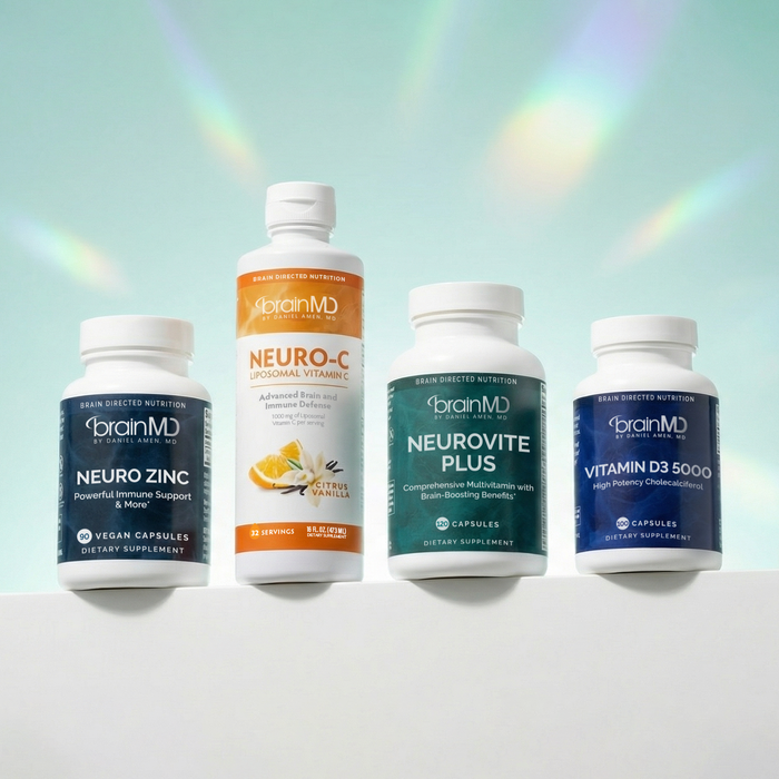 Four supplement bottles against a powder blue background.