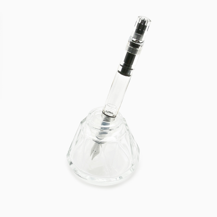 Clear TWSBI Diamond 50 ink bottle 50ml with fountain pen inserted.
