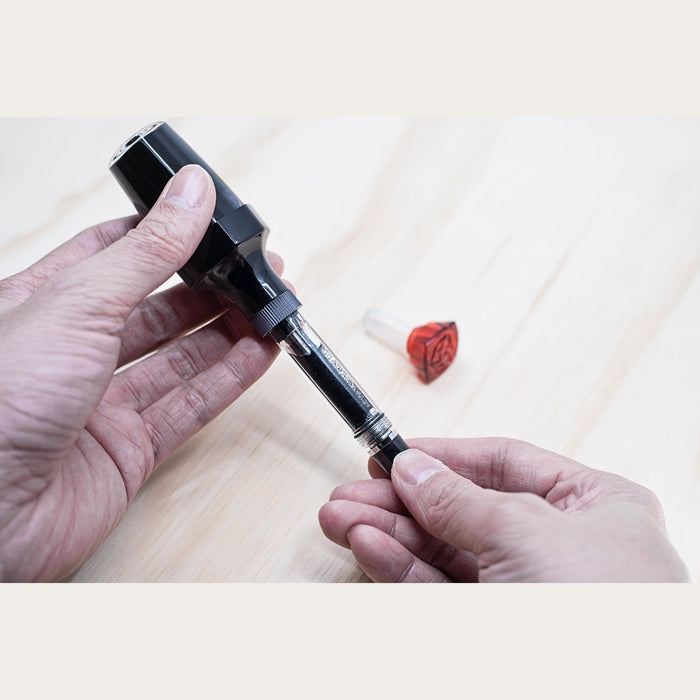 Filling a fountain pen using the TWSBI VAC 20 ink bottle vacuum system.