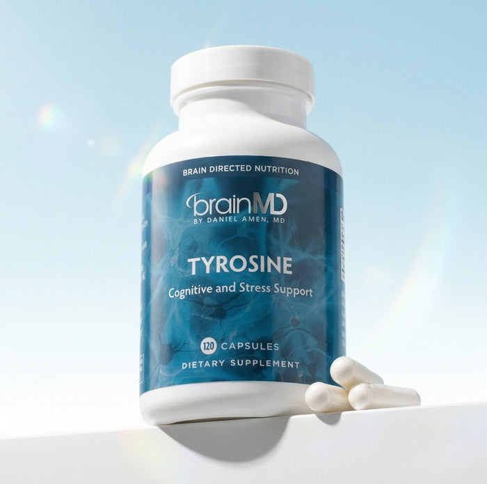Dark blue supplement bottle with white capsules at the base against a powder blue background.