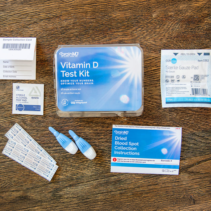 Everything included in the BrainMD Vitamin D Test Kit: sample collection card, lancets, alcohol wipe, gauze pad, bandages, instructions, and prepaid return envelope