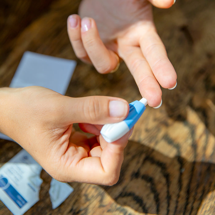 Using the lancet from a BrainMD at-home test kit for a simple finger-prick blood spot sample