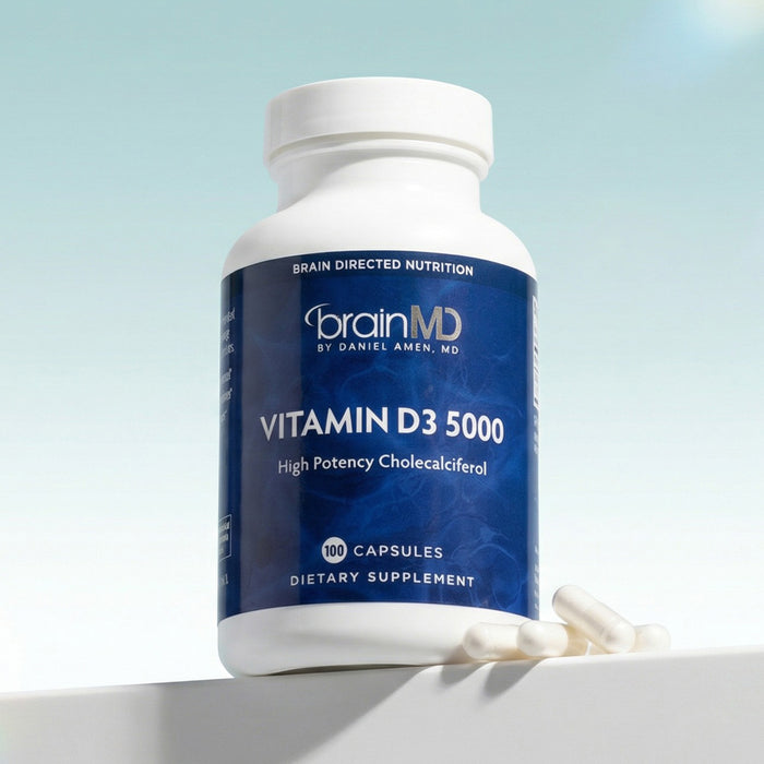 Dark blue supplement bottle against a powder blue background.